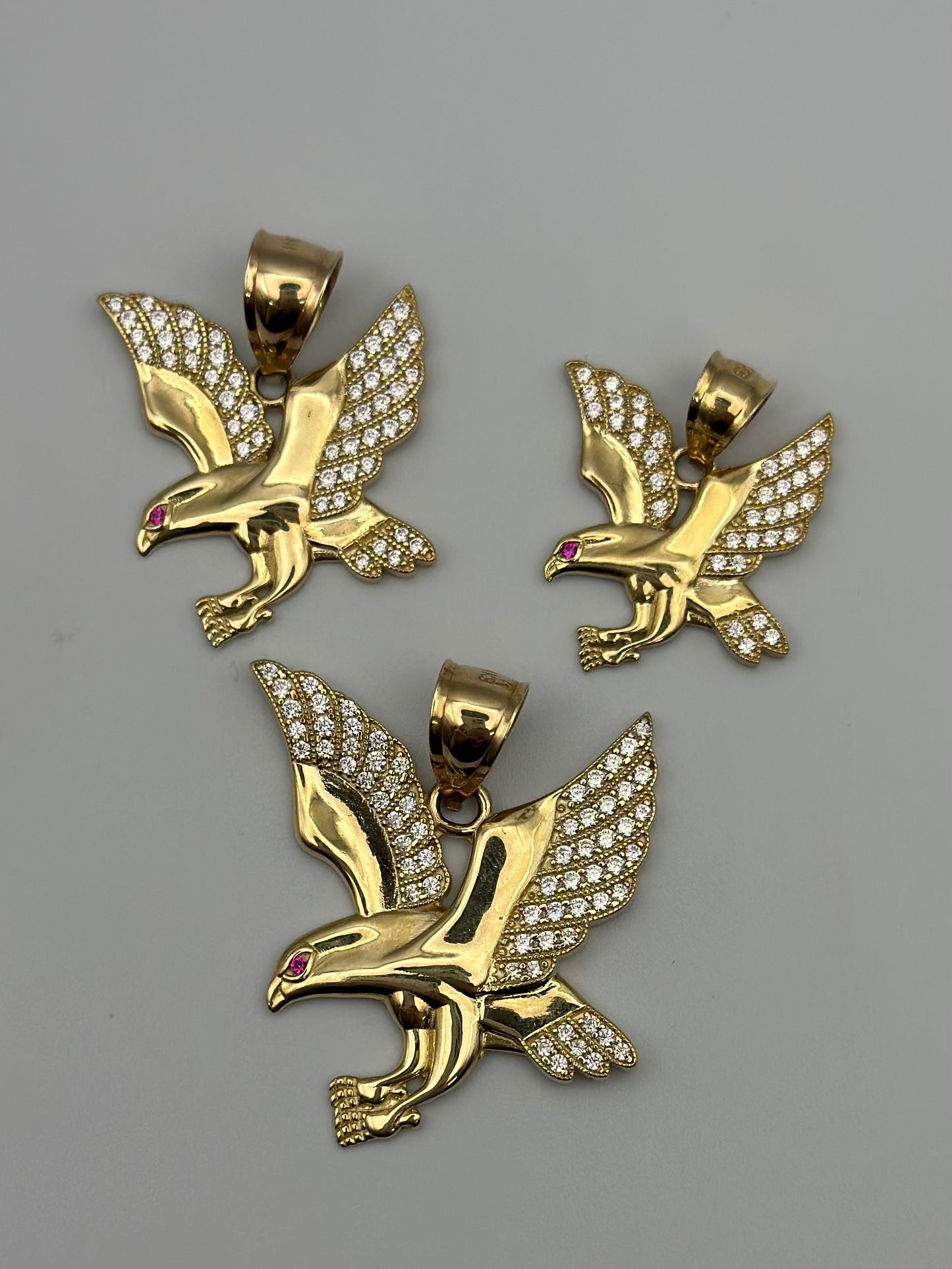 Eagle pendant with zirconia in 14k gold.