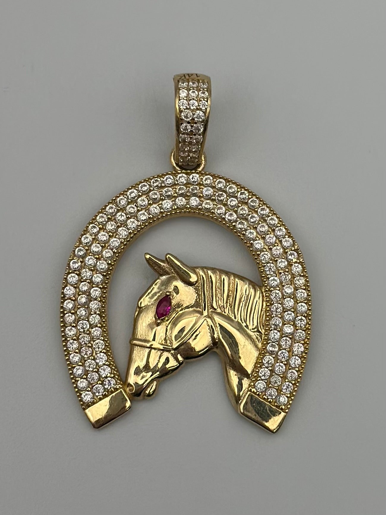 Horseshoe pendant with zirconia .