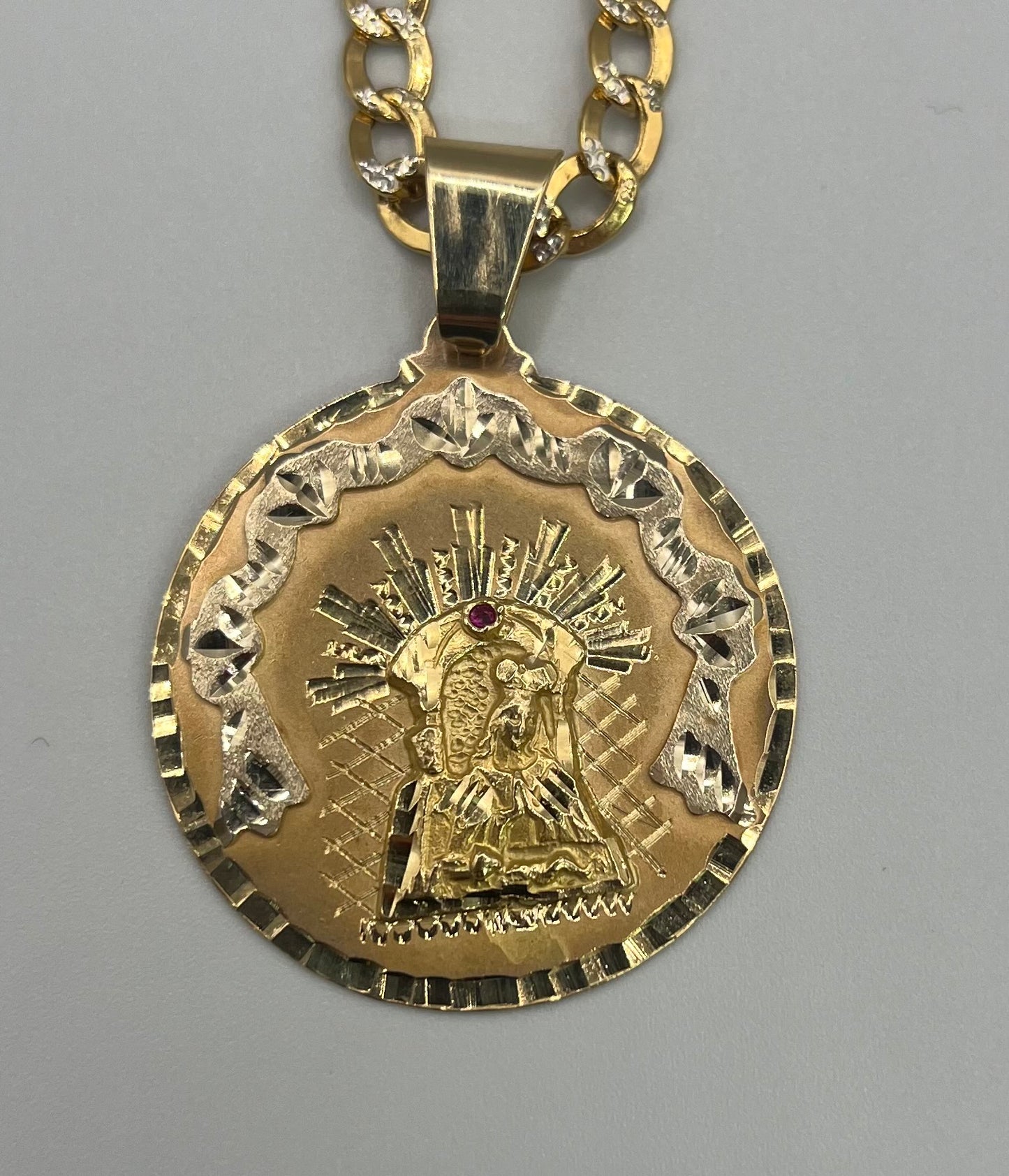 Double-tone hollow chain and solid medal with Virgin drawing.