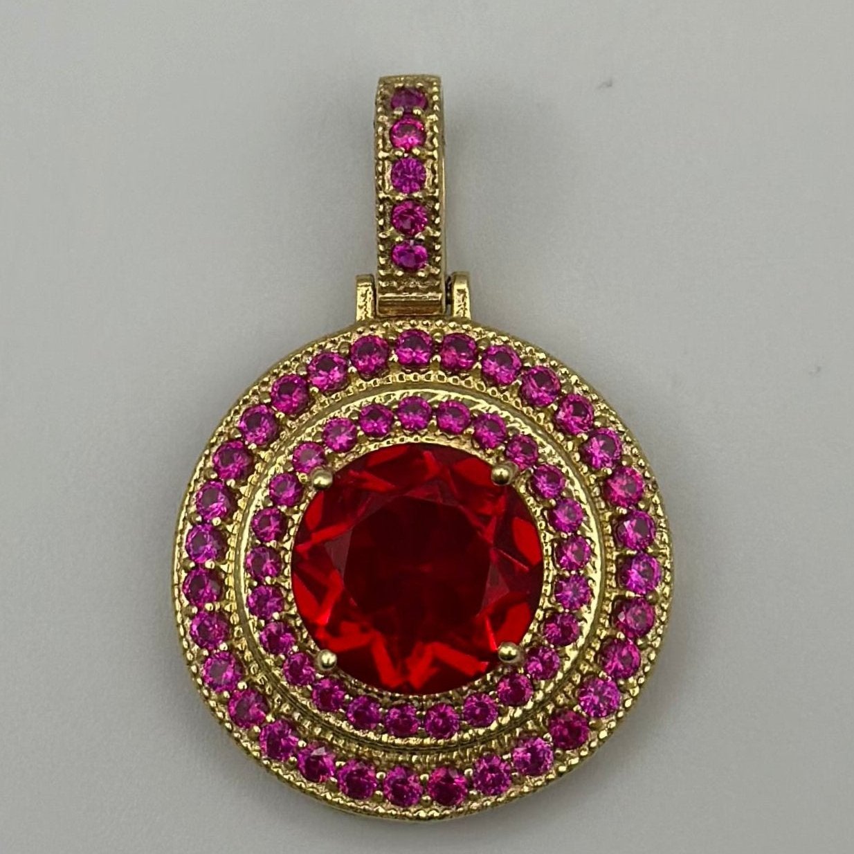 Pendant with red zirconia.