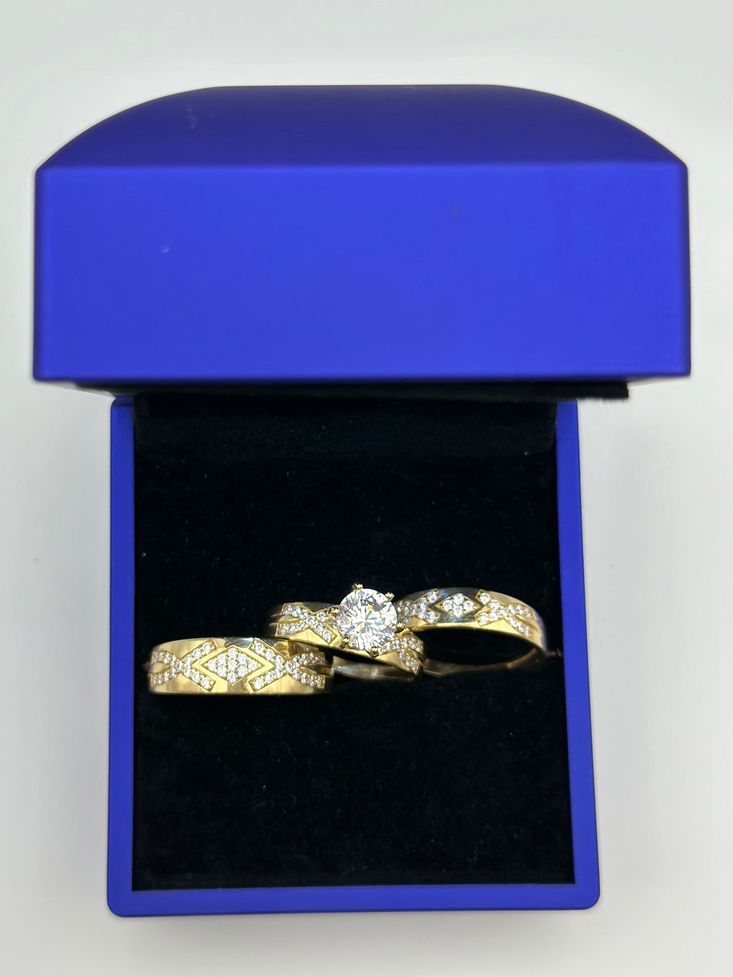 Trio of wedding rings with design.