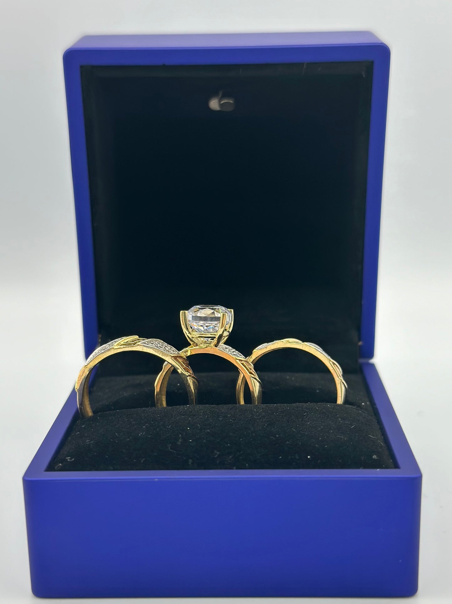 Trio of triple tone wedding rings .