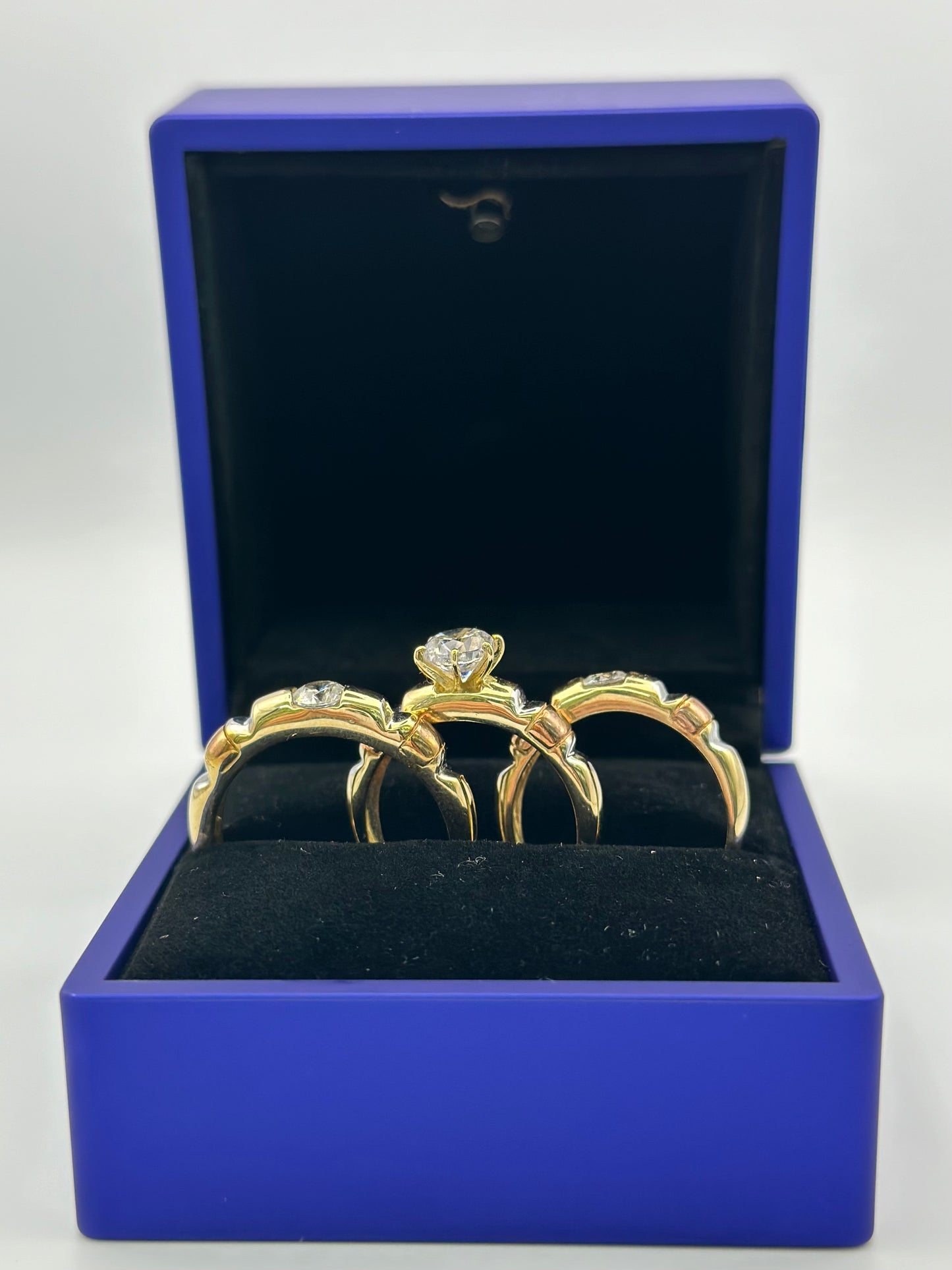 Trio of three-tone wedding rings.  12