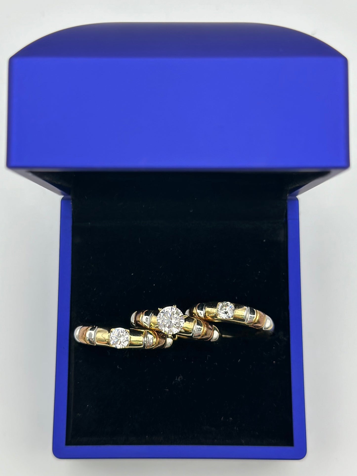 Trio of three-tone wedding rings.  12