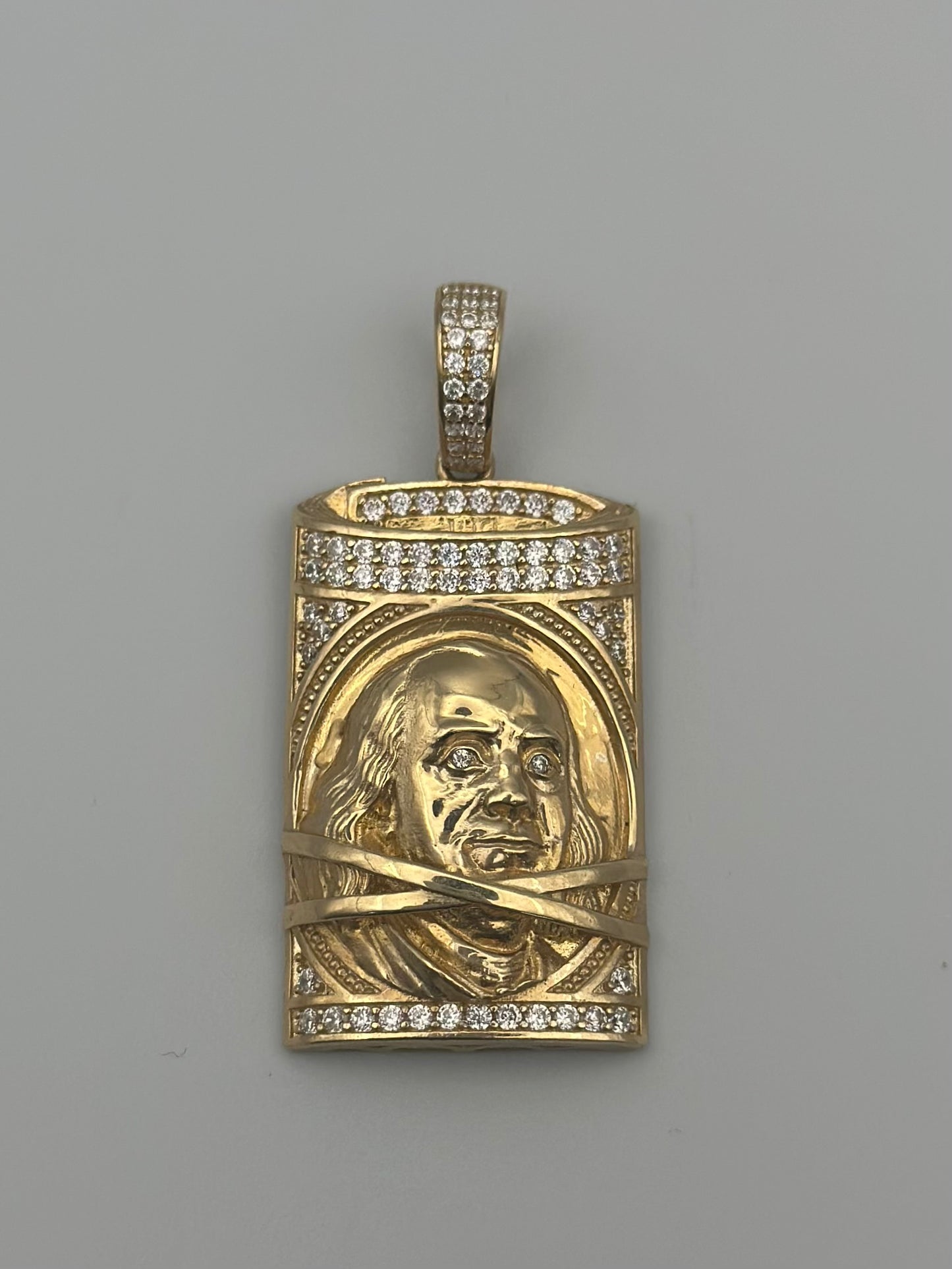 Medal with a design of 100-dollar bills.