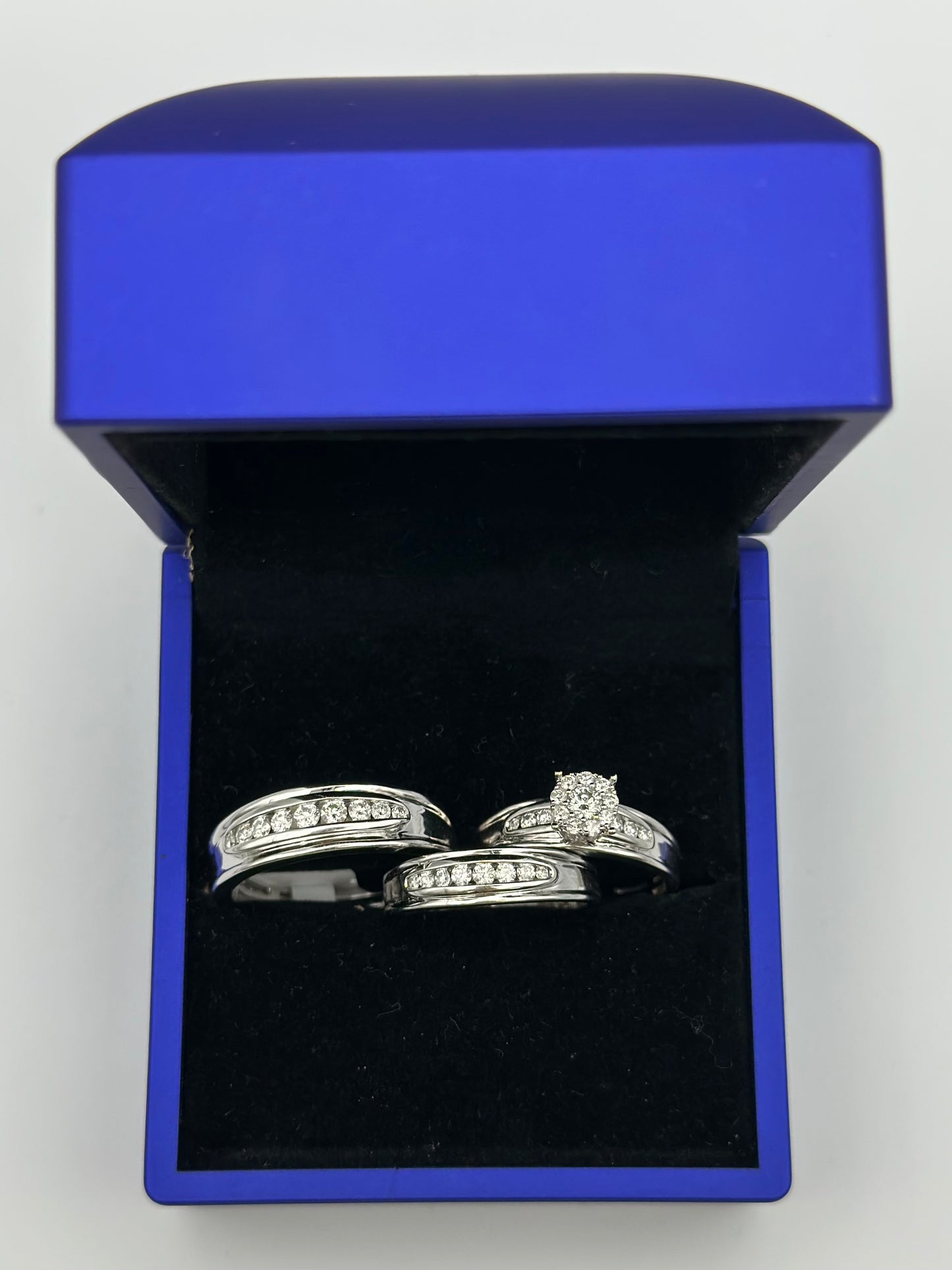 White trio of diamond wedding rings.